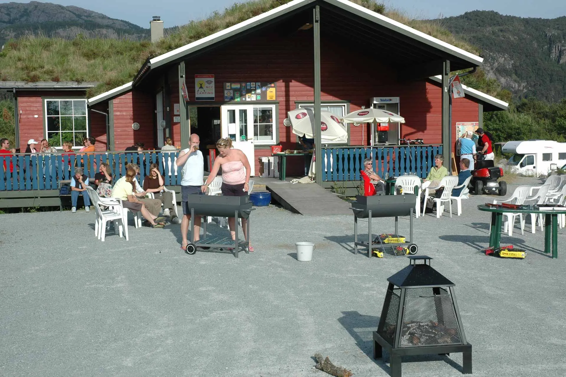 Guests on the terrace by the grills at Preikestolen Camping